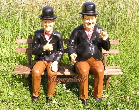 Stan Laurel & Oliver Hardy figures on bench