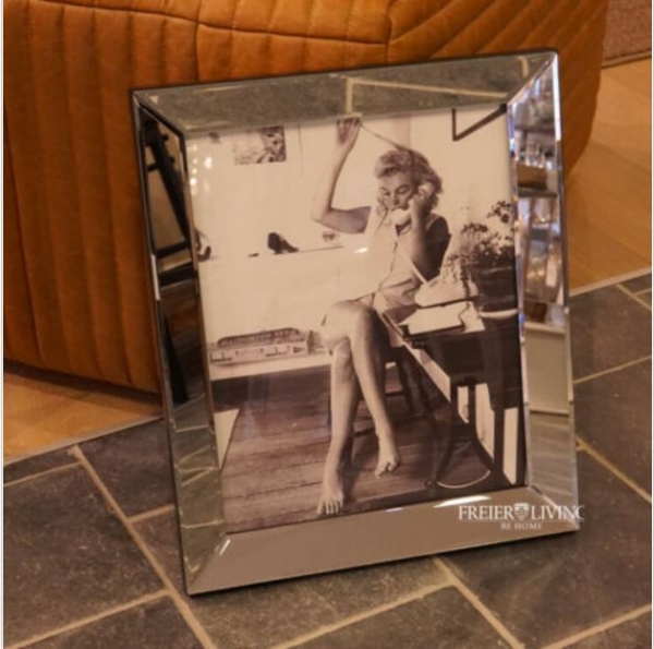 Legendary photo of Marilyn Monroe on the phone and mirror frame.